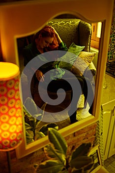 Vintage photo of Beautiful red haired young woman posing in old loft apartment in Tbilisi