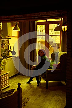 Vintage photo of Beautiful red haired young woman posing in old loft apartment in Tbilisi