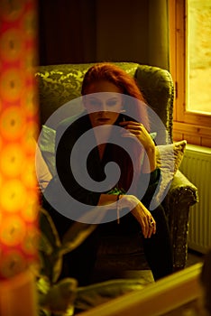 Vintage photo of Beautiful red haired young woman posing in old loft apartment in Tbilisi