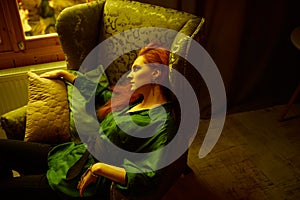 Vintage photo of Beautiful red haired young woman posing in old loft apartment in Tbilisi