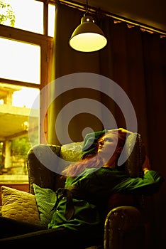 Vintage photo of Beautiful red haired young woman posing in old loft apartment in Tbilisi