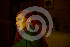 Vintage photo of Beautiful red haired young woman posing in old loft apartment in Tbilisi