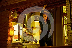 Vintage photo of Beautiful red haired young woman posing in old loft apartment in Tbilisi