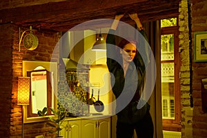 Vintage photo of Beautiful red haired young woman posing in old loft apartment in Tbilisi