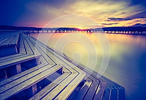 Vintage photo of beautiful sunset over calm lake