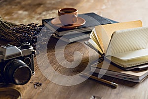 Vintage photo camera, and diaries and cup of coffee photo