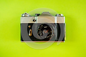Vintage Photo Camera on green background close up