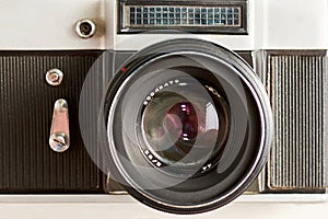 Vintage photo camera with optical lens and aperture blades, front view as icon