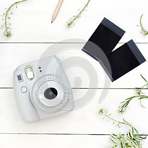 Vintage photo camera on white background with photo cards. Polaroid camera. Instax white camera. Flat lay.