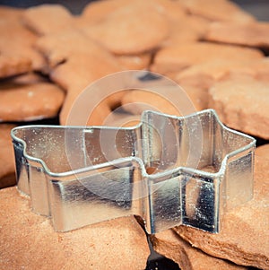 Vintage photo, Cookie cutters in shape of star and fresh baked gingerbread or cookies for Christmas