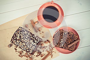 Vintage photo, Dark cake with chocolate, cocoa and plum jam, cup of coffee, delicious dessert