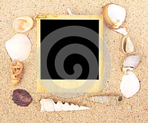 Vintage photo frame and Sea Shell on sand