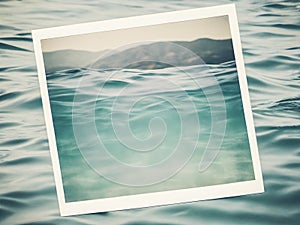 Vintage photo frame on the sea water background.