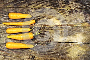 Vintage photo of Fresh carrots on wood table