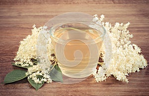 Vintage photo, Fresh healthy juice and elderberry flowers on rustic board