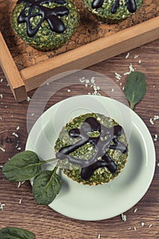 Vintage photo, Fresh muffins with spinach, desiccated coconut and chocolate glaze, delicious healthy dessert