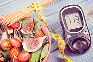 Vintage photo, Fruit and vegetable salad and glucometer with tape measure, concept of diabetes, slimming and healthy nutrition