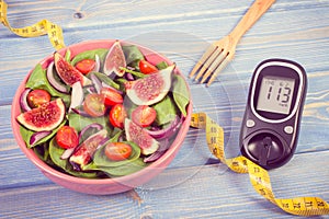 Vintage photo, Fruit and vegetable salad and glucometer with tape measure, concept of diabetes, slimming and healthy nutrition