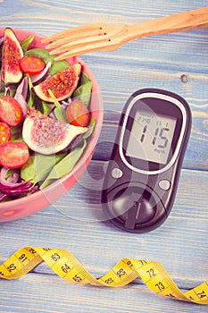 Vintage photo, Fruit and vegetable salad and glucometer with tape measure, concept of diabetes, slimming and healthy nutrition