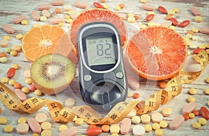 Vintage photo, Glucometer with result, centimeter, fruits and medical pills, diabetes, slimming, healthy lifestyle and nutrition