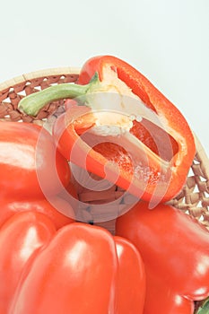 Vintage photo, Heap of red peppers in wicker basket on white background, concept of healthy nutrition