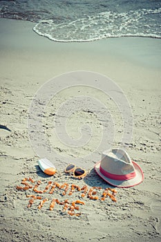 Vintage photo, Inscription summer time, sunglasses, sun lotion and straw hat on sand at beach, summer time