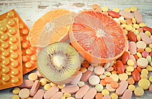 Vintage photo, Natural fruits and pills, choice between healthy nutrition and supplements