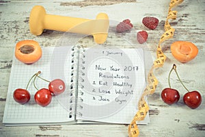 Vintage photo, New year resolutions written in notebook on old board