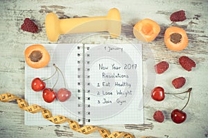 Vintage photo, New year resolutions written in notebook on old board