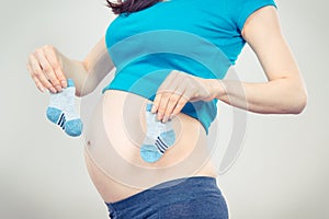 Vintage photo, Pregnant woman with socks for baby, expecting for baby