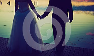 Vintage photo of wedding couple silhouettes in outdoor