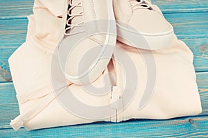 Vintage photo, Womanly clothing and accessories on old boards, leather shoes and sweatshirt