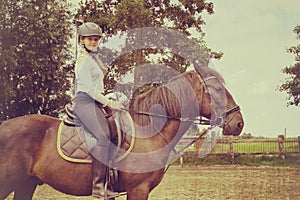 Vintage photo of young girl spending sometime with her horse. Love and friendship concep