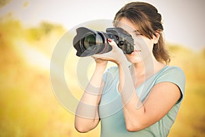 Vintage photo of a young woman photographer with camera in hand