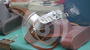 vintage photography equipment at a street sale. Old Cameras lying on the counter