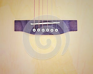 Vintage phto of acoustic guitar strings on wooden table in the room, close up top view and sunlight with empty space for you text