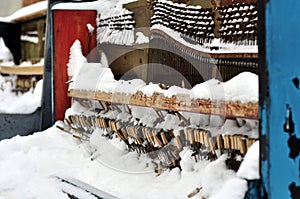 Vintage Piano musical instrument under the snow.