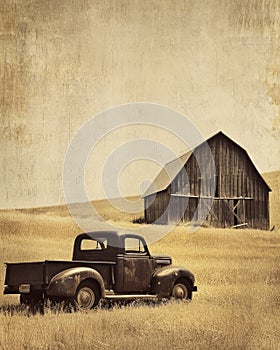 Vintage Pickup Truck in a Field with Barn in the Background