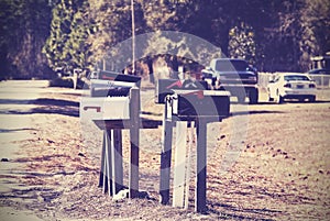 Vintage picture of mail boxes, rural area, USA.