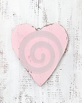 Vintage pink heart on a wooden background