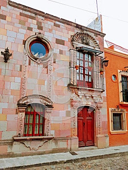 Vintage pink and orange building Mexican streetscape in san miguel allende mexico