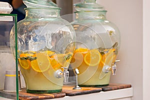 Vintage pitcher of homemade lemonade, mojito with mint and orange slices