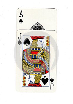 Vintage playing cards showing an ace and jack of spades.