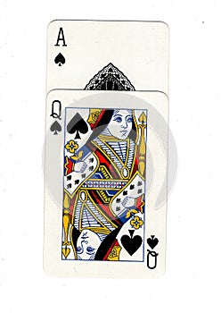 Vintage playing cards showing an ace and queen of spades.