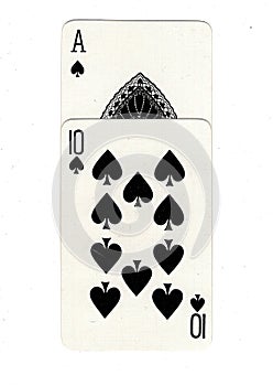 Vintage playing cards showing an ace and ten of spades.