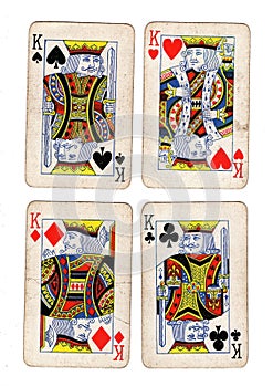 Vintage playing cards showing four kings.