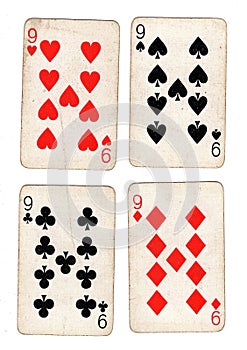 Vintage playing cards showing four nines. photo