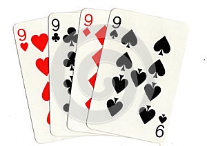 Vintage playing cards showing a hand of four nines. photo