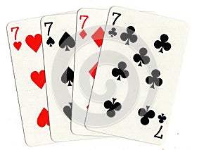 Vintage playing cards showing a hand of four sevens.