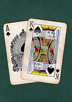 Vintage playing cards showing a king and ace of spades.